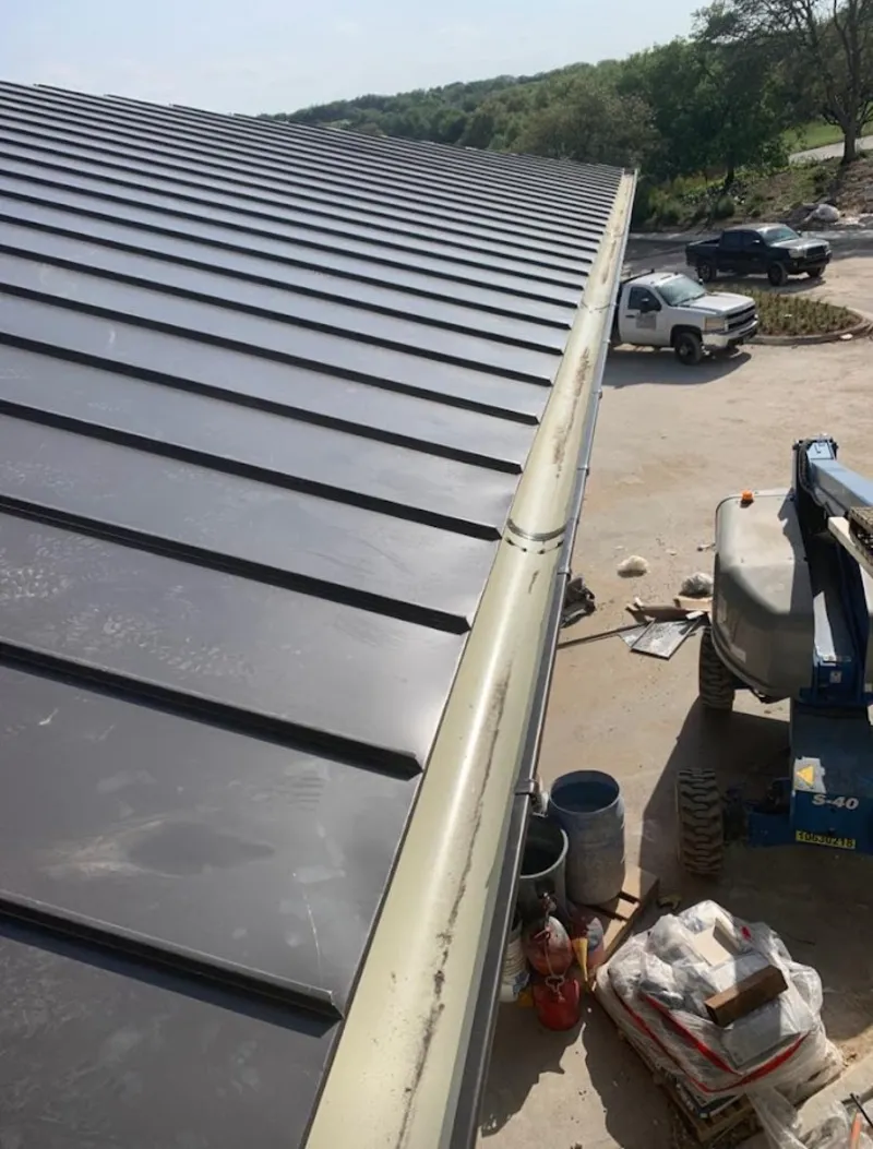 Standing seam panel and gutter detail on a metal roofing jobsite in Princeton